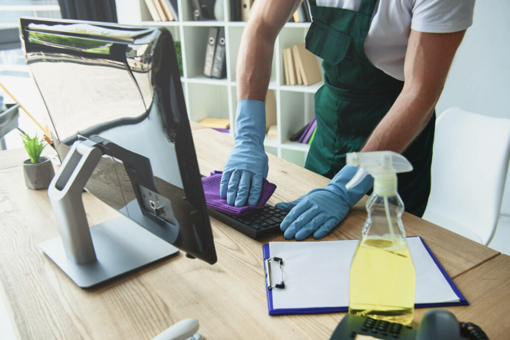 cropped shot of professional cleaner in rubber gloves cleaning c